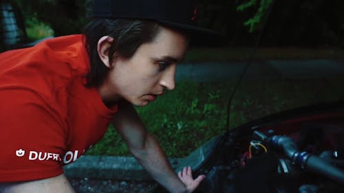 A Man Checking his Car's Engine