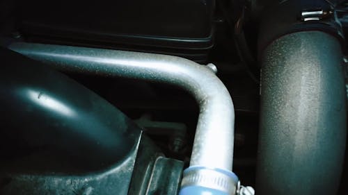 A Mechanic Working On A Car Engine