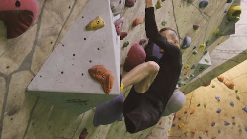 A One Legged Man Engaged In Wall Climbing