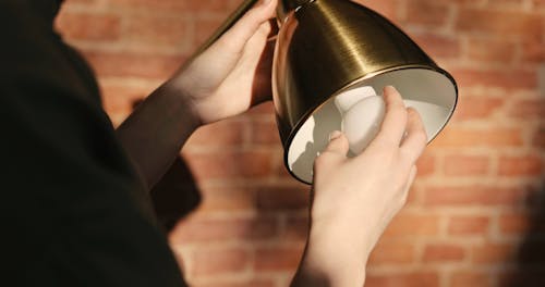 Putting A Light Bulb On A Lamp Shade