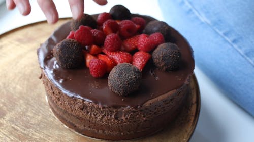 A Person Decorating a Cake