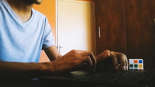 A Man Typing in his Computer