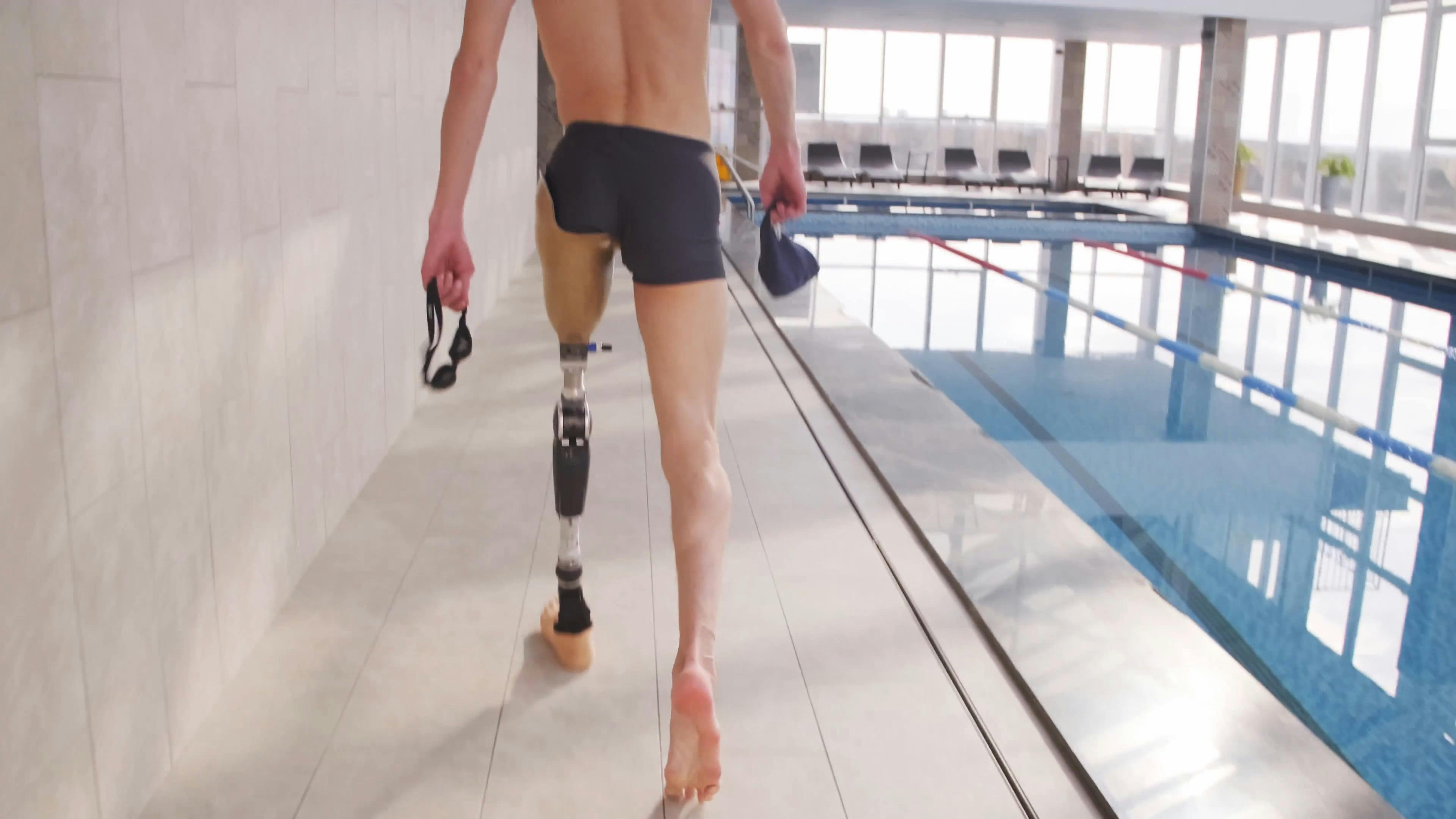 Man With Prosthetic Leg Walking On Poolside · Free Stock Video