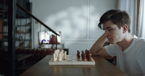 A Man Playing Chess Game Alone Changing Sides Every Move Made