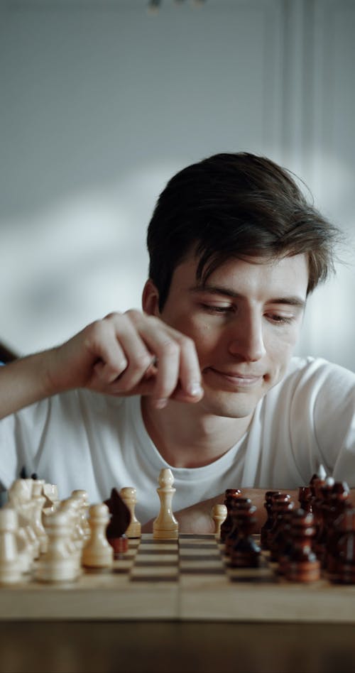 A Man Playing A Game Of Chess Alone