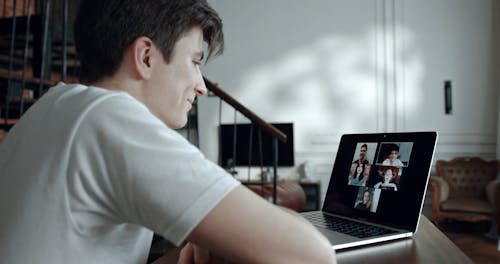 A Man In A Video Conference Using His Laptop