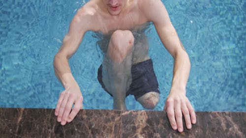 A Man Swimming in the Pool