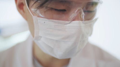 A Man Wearing Goggles And Mask Inside The Laboratory