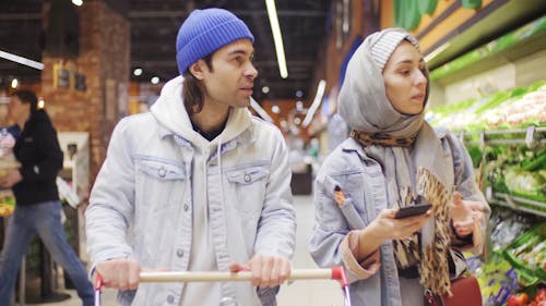 A Couple Buying Stuffs In A Grocery