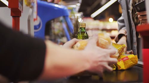 Couple Paying at the Counter in the Grocery