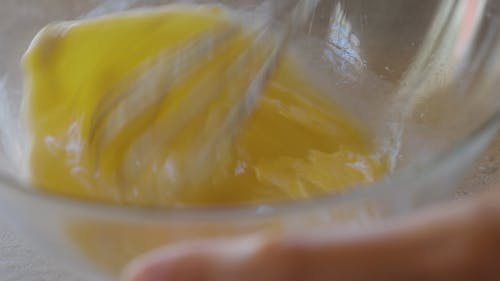 Person Beating An Egg Briskly With A Whisk