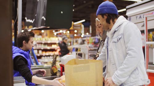 A Couple Shopping For Food In A Supermarket