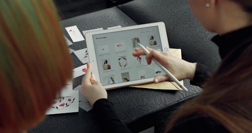 A Tattoo Artist Showing a Customer A Tattoo Design Using An Ipad