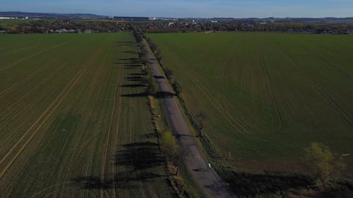 Drone Footage of Roadway Between Farmlands