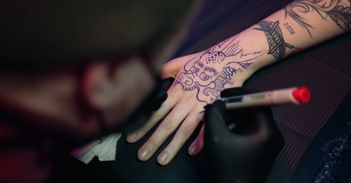 Using A Pen With Red Ink As Draft Of A Dragon Design Tattoo · Free ...