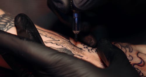 Close-up Footage Of The Art Of Tattooing