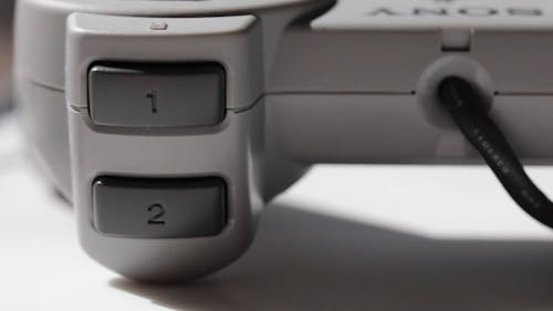 Close-Up Shot of a Play Station Console and Controller