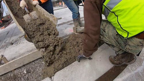 Men Pouring Concrete Mix