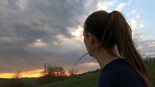 A Woman Walking While Watching The Beauty Of Sunset