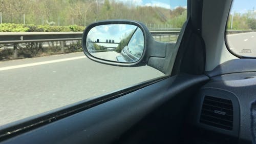 A Video of the Road from the Side Mirror of a Moving Car