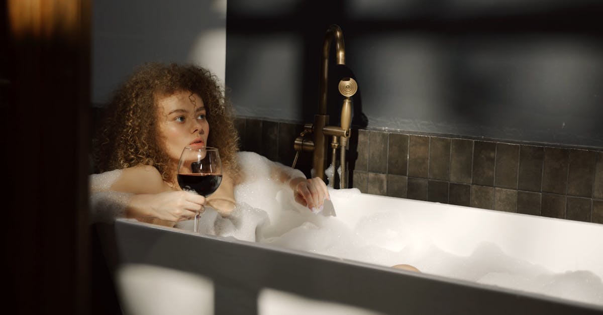 A Woman Drinking Wine While Soaked In A Bathtub · Free