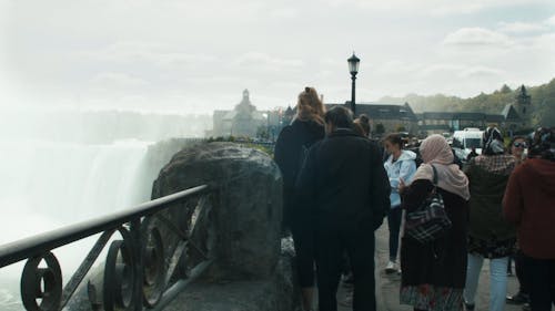 A Crowd Of Tourists Watching The Niagara Falls