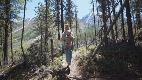 Mother With Her Baby Walking In The Woods