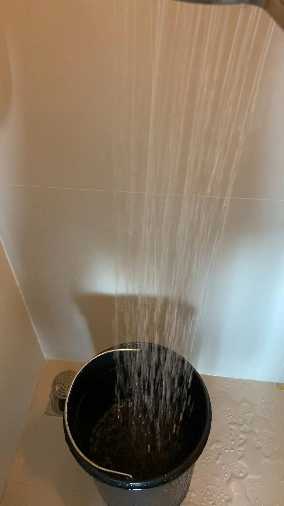 Filling A Bucket With Water Using he Shower Head · Free Stock Video