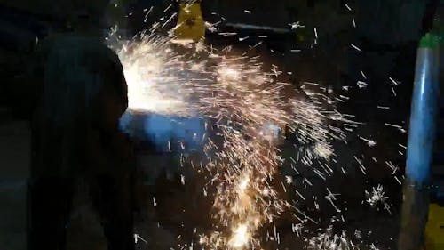A Person Welding Steel in the Workshop