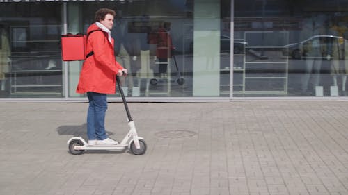 A Man Riding a Scooter