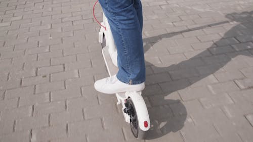 A Deliveryman Using A Scooter 