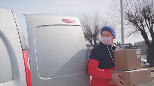 A Delivery Man Wearing A Mask In Making The Deliveries