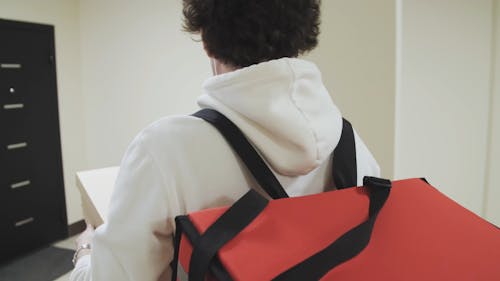 A Customer Receiving Boxes Of Pizza From The Deliveryman At His Residence