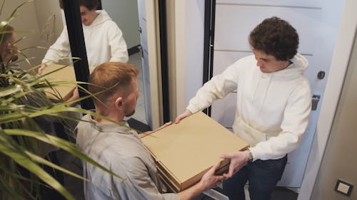 A Customer Receiving Food Delivery By The Door Entrance