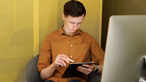 Man Using His Tablet with Stylus Pen