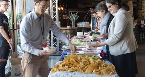 Guests Lining Up Getting Food In A Buffet