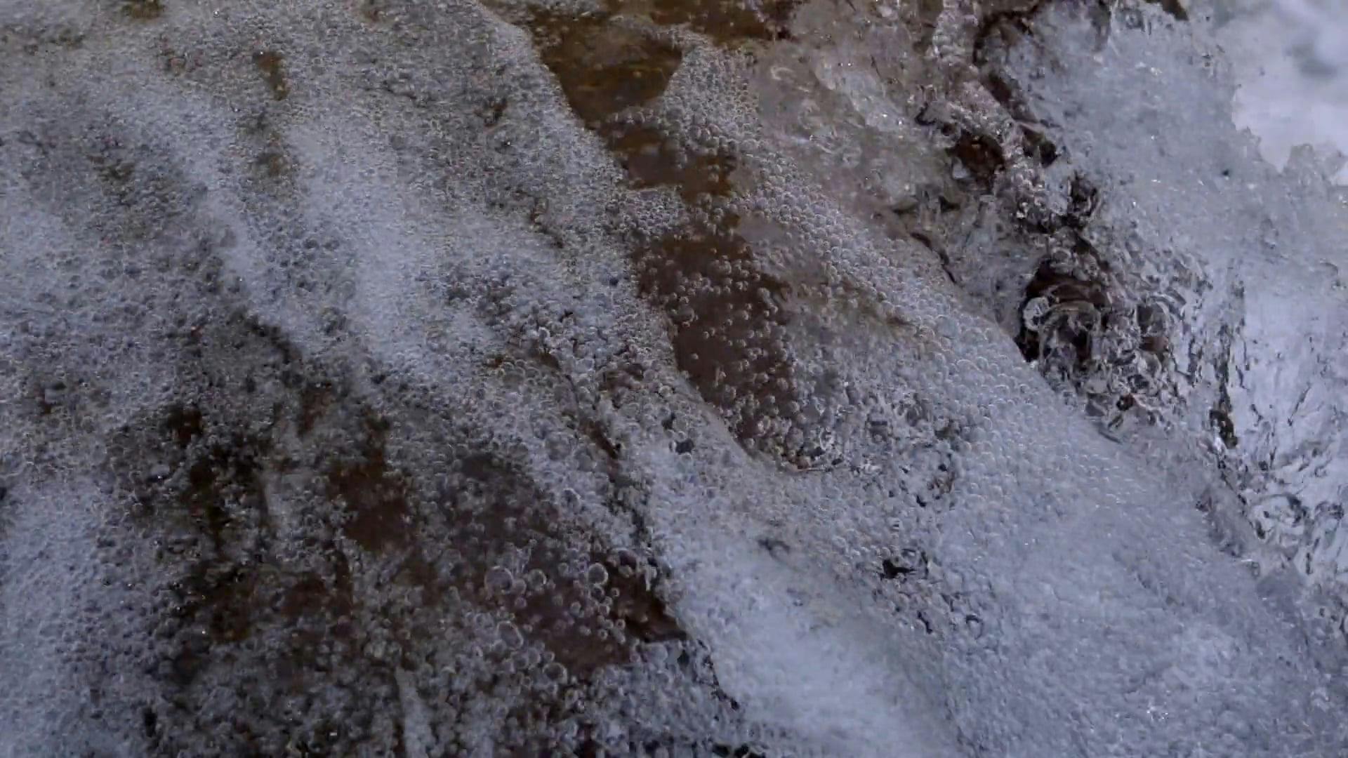 a close up shot of water crashing into rocks 4174030