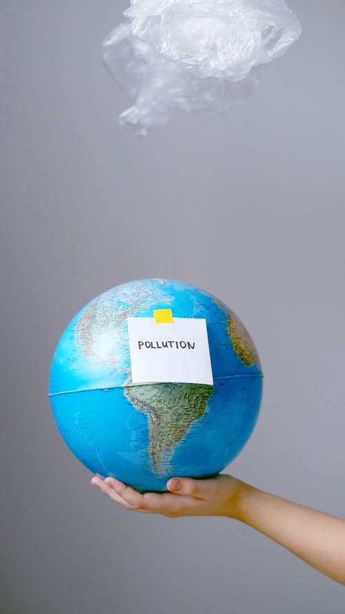 Person Holding A Globe With Concept Of Pollution