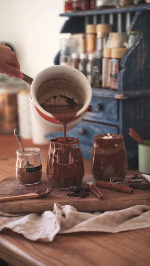 A Person Pouring Hot Chocolate in a Cup