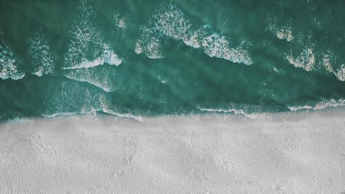 Top View of Beach Waves Crashing on Seashore