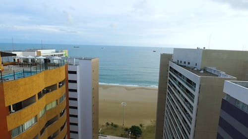 Drone Flying Over The Beach In Front Of Hotels And Resorts