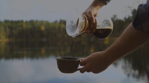 A Person Pouring Coffee in the Cup