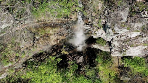 A Waterfall Cascading Down The Mountain Cliffs 