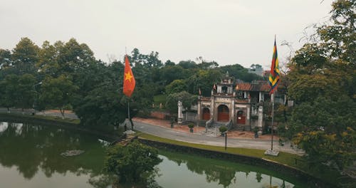 A Drone Shot of a Village Gate Surrounded by Trees