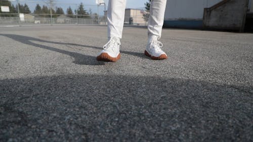 Person Wearing White Sneakers