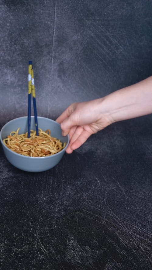 Two Bowls Of Noodle Dish With Chopsticks 