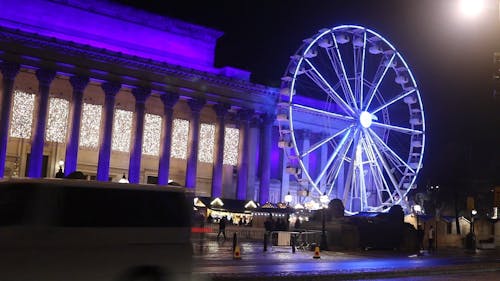 Video Of A Ferris Wheel In Front Of A Building