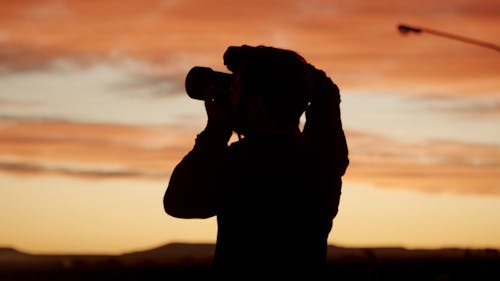 Silhouette Of A Man Taking Photos