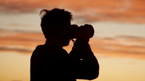 Silhouette Of Man Taking Photos