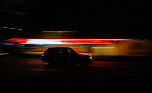 Blazing Neon Lights Surrounding A Stopped Car